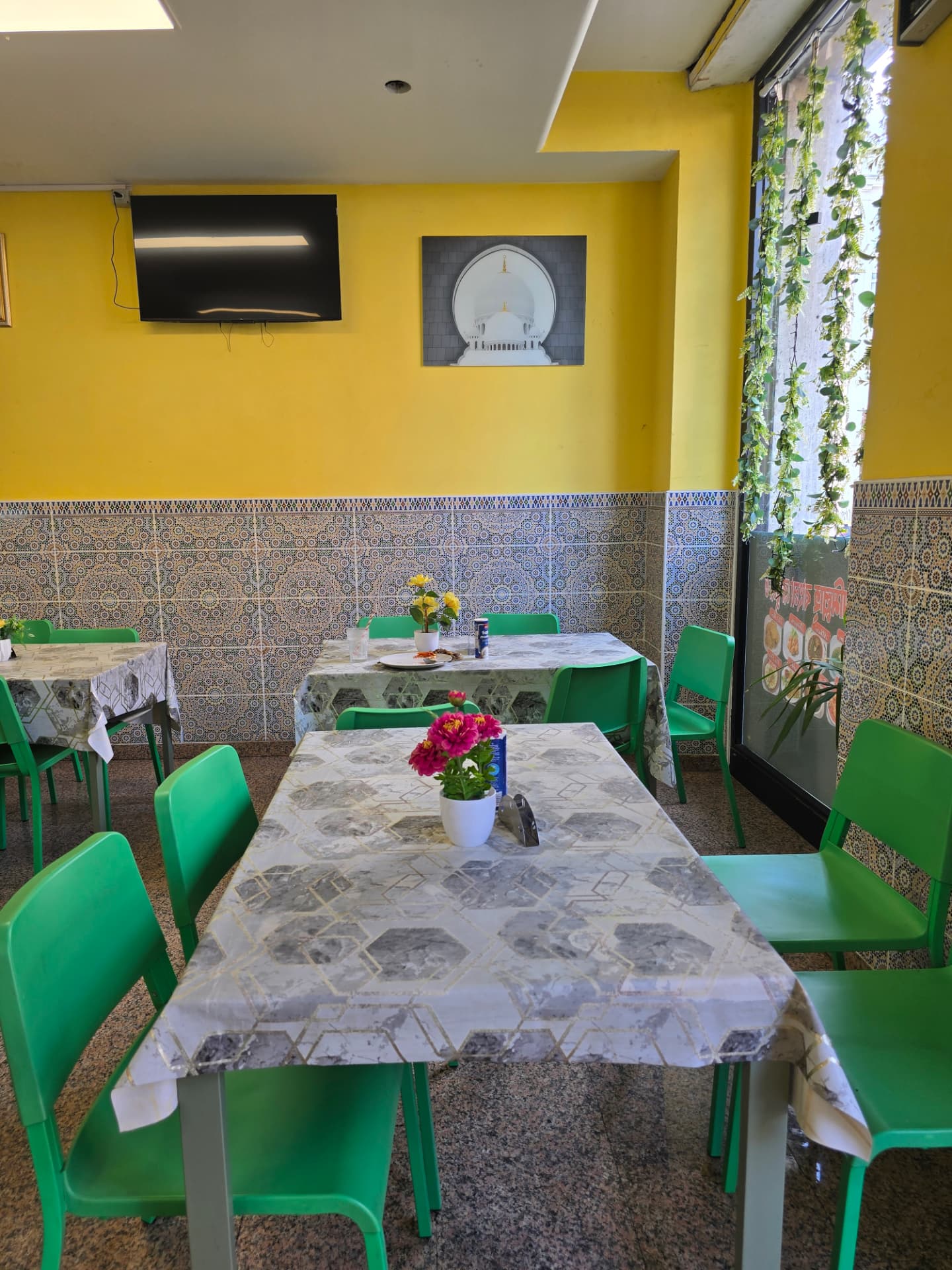 Bismillah Bangla Restaurant — seating area by the window with mosaic tiled walls