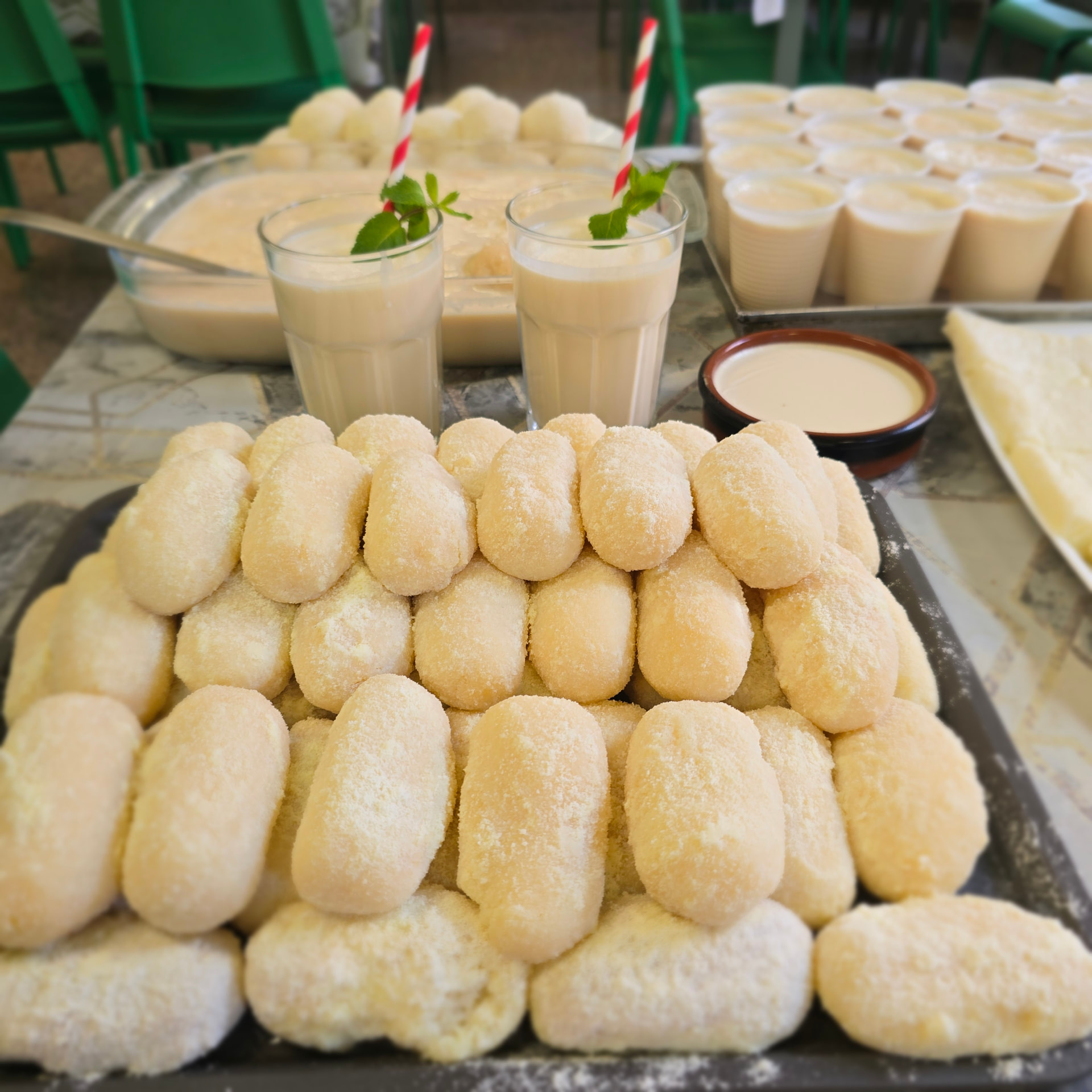 Bismillah Bangla Restaurant — tray of chomchom sweets with glasses of lassi