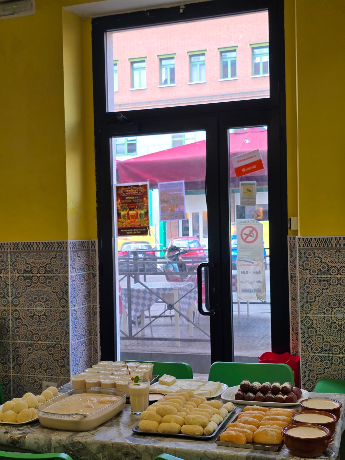 Bismillah Bangla Restaurant — table of fresh Bengali sweets and lassi by the entrance door